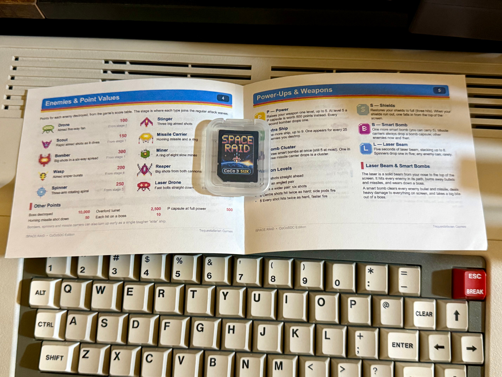 Space Raid instruction manual open to the enemies and power-ups reference pages